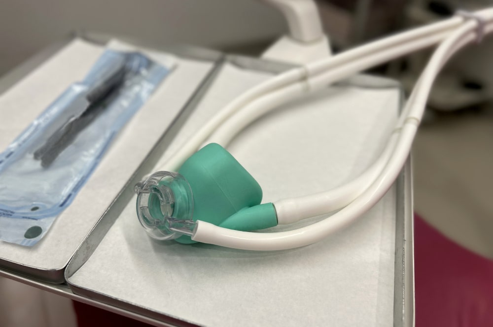 Pediatric dental patient inhaling nitrous oxide through a nose mask